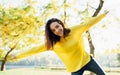 Cheerful young teenage girl posing outside in nature park. Pretty young beautiful student female resting outdoors on the city park Royalty Free Stock Photo