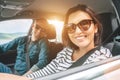 Cheerful young traditional couple has a long auto journey. Safety riding car concept wide angle inside car view image Royalty Free Stock Photo