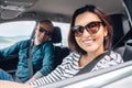 Cheerful young traditional couple has a long auto journey. Safety riding car concept wide angle inside car view image Royalty Free Stock Photo