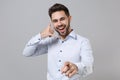 Cheerful young unshaven business man in light shirt isolated on grey background. Achievement career wealth business