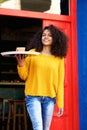 Cheerful young waitress with tray and cup of coffee Royalty Free Stock Photo