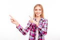 Cheerful young woman with beaming smile pointing away Royalty Free Stock Photo