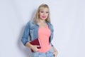 Beautiful blond young woman in pink tank top and jeans costume Royalty Free Stock Photo