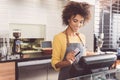 Cheerful young woman cashier is working in cafe Royalty Free Stock Photo