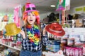 Cheerful young woman choosing funny headdresses