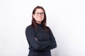 Cheerful young woman with crossed arms looking at the camera over white background Royalty Free Stock Photo