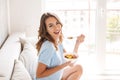 Cheerful young woman eating healthy breakfast Royalty Free Stock Photo