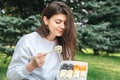 A young woman eating sushi in the park, picnic in nature. Royalty Free Stock Photo