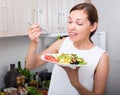 Smiling woman eating salad Royalty Free Stock Photo