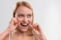 Cheerful young woman flossing her tooth Royalty Free Stock Photo