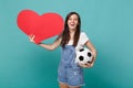 Cheerful young woman football fan cheer up support favorite team with soccer ball, empty blank red heart isolated on Royalty Free Stock Photo