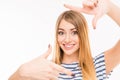 Cheerful young woman gesturing finger frame and smiling, close up photo Royalty Free Stock Photo