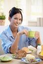 Cheerful young woman having breakfast Royalty Free Stock Photo