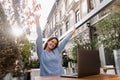 Cheerful young woman is having fun online with friends and family. Happy girl with laptop is chatting and greeting with Royalty Free Stock Photo