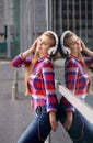 Cheerful young woman with headphones listening to music Royalty Free Stock Photo