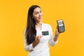 Cheerful young woman holding wireless modern bank payment terminal to process and acquire credit card payments isolated Royalty Free Stock Photo