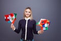 Cheerful young woman with a large set of flags of different countries of the world Royalty Free Stock Photo