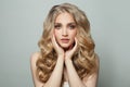 Cheerful young woman with long perfect blonde hair on white background