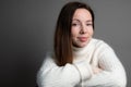 Cheerful young woman looking at camera, smiling, laughing on gray background. Close up of female face. Natural beauty Royalty Free Stock Photo