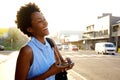 Cheerful young woman with mobile phone on the city street Royalty Free Stock Photo