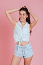 Cheerful young woman posing with hands raised and looking away Royalty Free Stock Photo