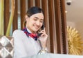 Cheerful young woman receptionist talking on the phone at workplace, Portrait of Female receptionist working in hotel Royalty Free Stock Photo