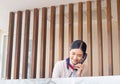 Cheerful young woman receptionist talking on the phone at workplace, Portrait of Female receptionist working in hotel Royalty Free Stock Photo