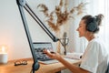 Cheerful young woman recording podcast at home studio Royalty Free Stock Photo