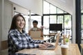 Young woman sitting in creative office and smiling to camera. Royalty Free Stock Photo