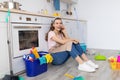 Cheerful woman speaking on cellphone during break from housework, enjoying phone conversation with friend at kitchen Royalty Free Stock Photo