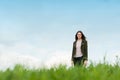 Cheerful young woman standing outside on green meadow Royalty Free Stock Photo