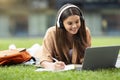 Cheerful young woman student attending online class, using laptop Royalty Free Stock Photo