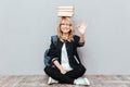 Cheerful young woman student holding books on head. Royalty Free Stock Photo