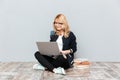 Cheerful young woman student using laptop computer. Royalty Free Stock Photo