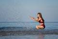 Cheerful woman in swimsuit playing water splashing on the sea beach at Koh Chang island, Thailand Royalty Free Stock Photo