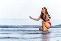 Cheerful woman in swimsuit playing water splashing on the sea beach at Koh Chang island, Thailand Royalty Free Stock Photo