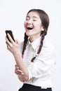 Cheerful young woman using cell phone against white background Royalty Free Stock Photo