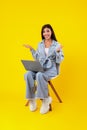 Cheerful young woman using laptop celebrating success Royalty Free Stock Photo