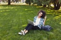 Cheerful young woman using laptop in park Royalty Free Stock Photo