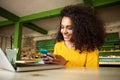 Cheerful young woman using mobile phone in a cafe Royalty Free Stock Photo
