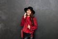 Cheerful young woman wearing hat talking by mobile phone Royalty Free Stock Photo