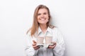 Cheerful young woman in white shirt holding two cups of coffee to take away Royalty Free Stock Photo