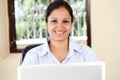 Cheerful young woman woking on computer