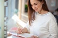 Cheerful young woman writing and keeping her personal a daily diary books. Royalty Free Stock Photo