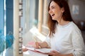 Cheerful young woman writing and keeping her personal a daily diary books. Royalty Free Stock Photo