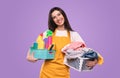 Happy housewife with laundry and detergents Royalty Free Stock Photo