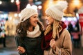 Cheerful young women friends at christmas time are having fun and shopping presents for their family Royalty Free Stock Photo