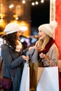 Cheerful young women friends at christmas time are having fun and shopping presents for their family Royalty Free Stock Photo