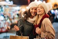 Cheerful young women friends at christmas time are having fun and shopping presents for their family Royalty Free Stock Photo