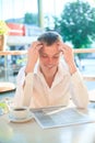 Cheerfull man reading a newspaper in a street cafe at lunch. Royalty Free Stock Photo